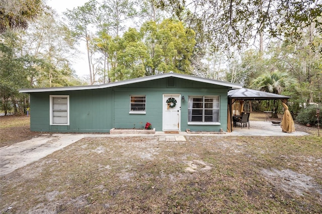 view of front of property featuring a patio area and a gazebo