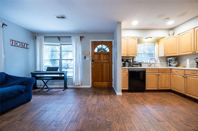 kitchen with dark hardwood / wood-style flooring, light brown cabinetry, dishwasher, and sink