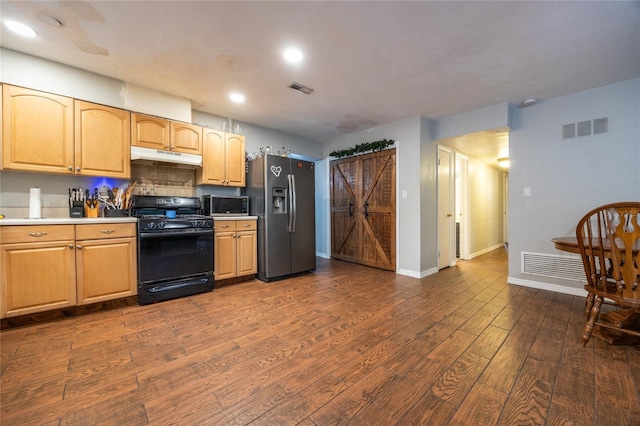 kitchen featuring dark hardwood / wood-style floors, stainless steel appliances, and backsplash