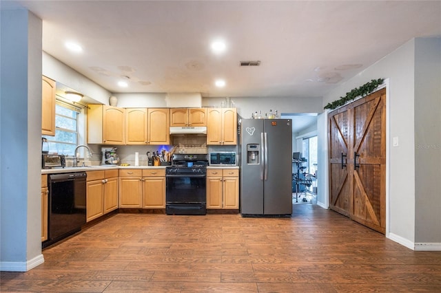 kitchen with black appliances, decorative backsplash, dark hardwood / wood-style floors, and sink