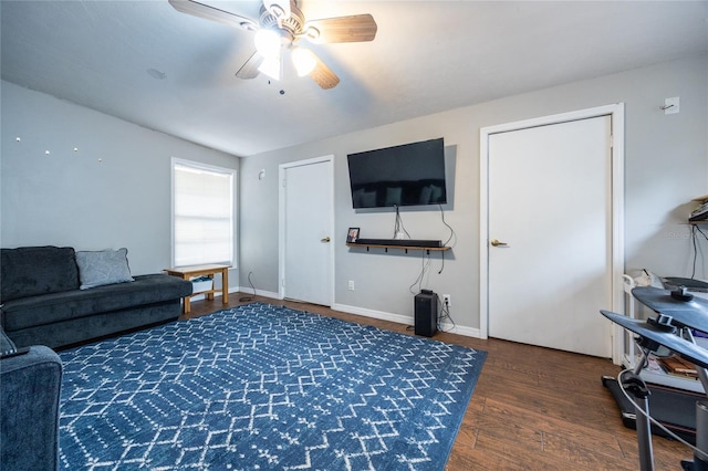 living room with ceiling fan, dark hardwood / wood-style flooring, and lofted ceiling