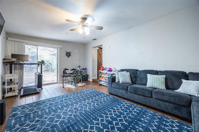 living room featuring ceiling fan and hardwood / wood-style flooring