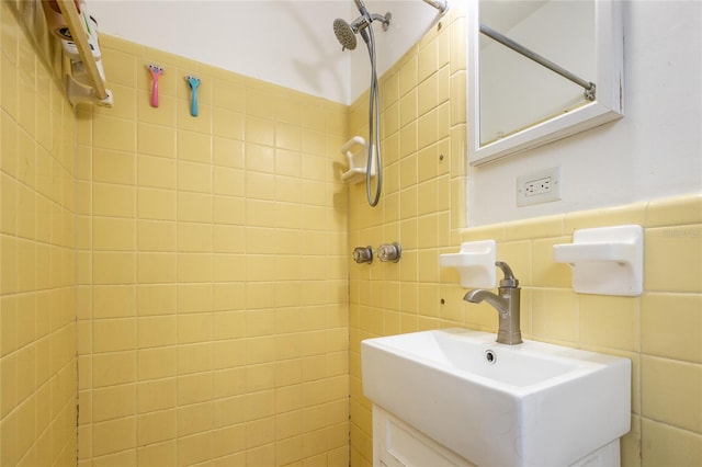 bathroom featuring tile walls, tiled shower, and vanity