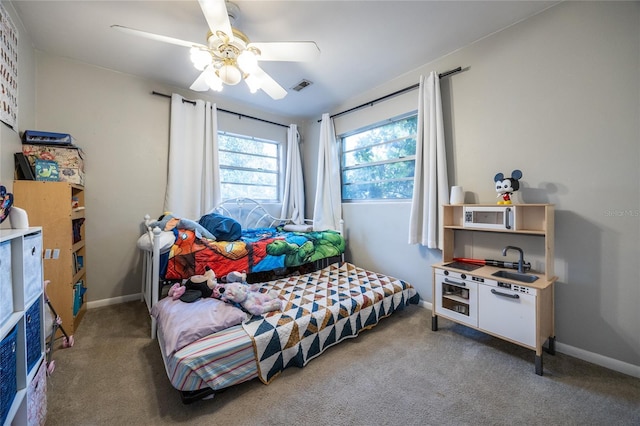 bedroom with ceiling fan and carpet