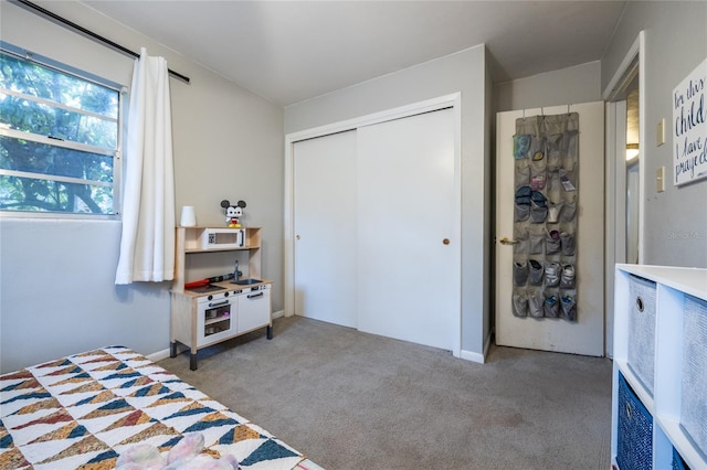 bedroom with carpet and a closet