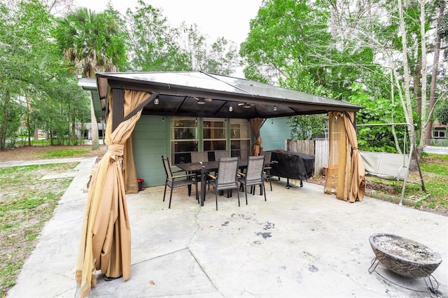 view of patio featuring a gazebo, a fire pit, and grilling area