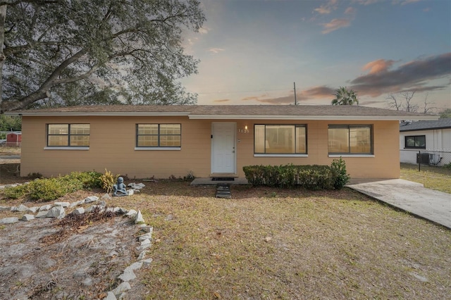 ranch-style home with a lawn