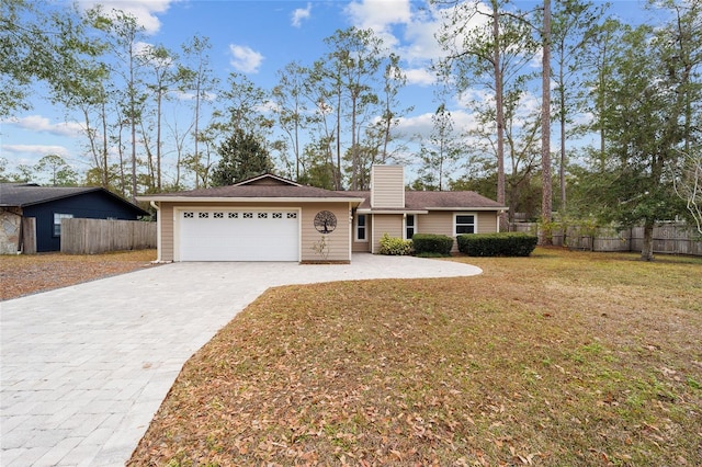 ranch-style home with a front lawn and a garage