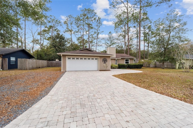 ranch-style home featuring a front lawn and a garage