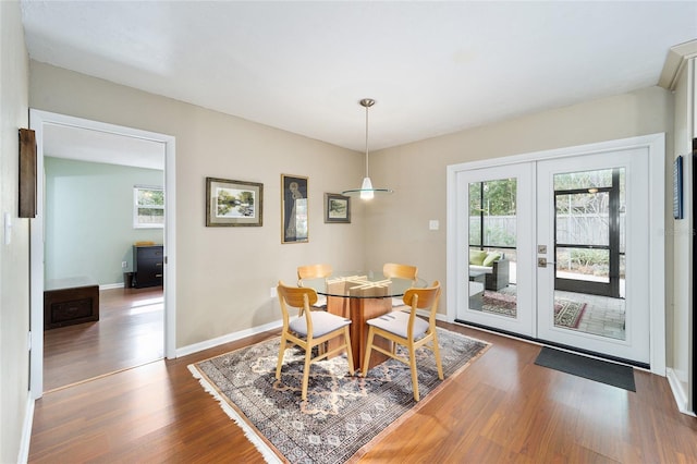 dining space featuring dark hardwood / wood-style flooring and french doors