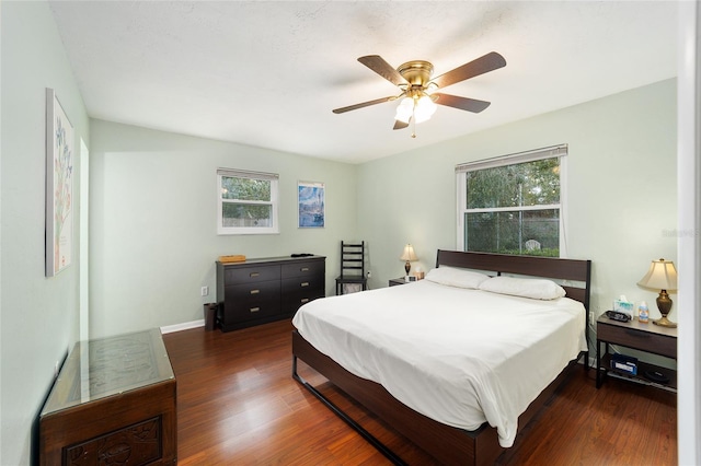 bedroom with ceiling fan and dark hardwood / wood-style flooring