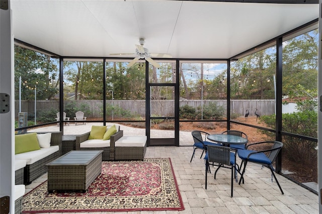 sunroom featuring ceiling fan