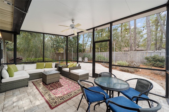 sunroom featuring ceiling fan