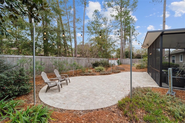 view of patio / terrace with ceiling fan and a sunroom