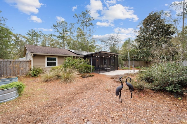 exterior space featuring a patio area and a sunroom