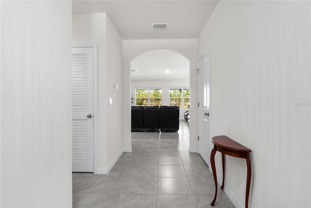 hall featuring light tile patterned flooring