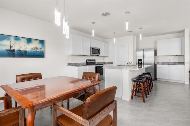 dining area with sink and light tile patterned flooring