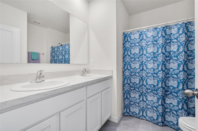 bathroom with tile patterned floors, toilet, and vanity