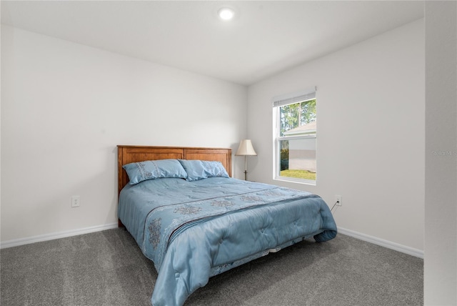 bedroom featuring dark colored carpet