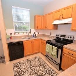 3930 SW 20th Ave Unit 1905, Gainesville, FL 32607 - kitchen with under cabinet range hood, stainless steel electric range oven, dishwasher, a sink, and light brown cabinets