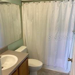 3930 SW 20th Ave Unit 1905, Gainesville, FL 32607 - bathroom featuring vanity, toilet, and shower / tub combo with curtain