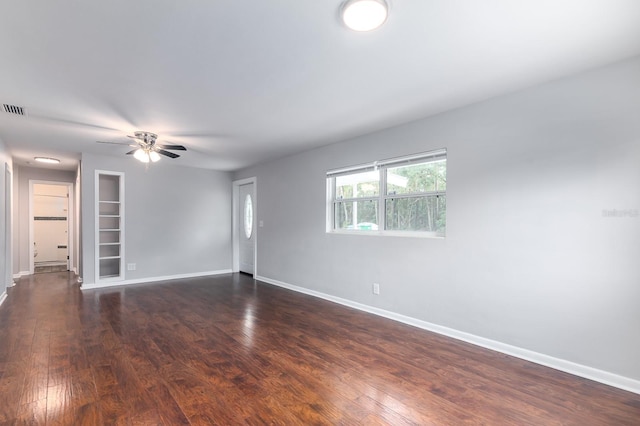 unfurnished room with ceiling fan and dark hardwood / wood-style flooring