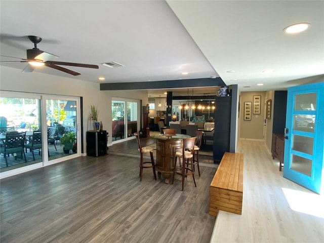 dining space with ceiling fan and wood-type flooring