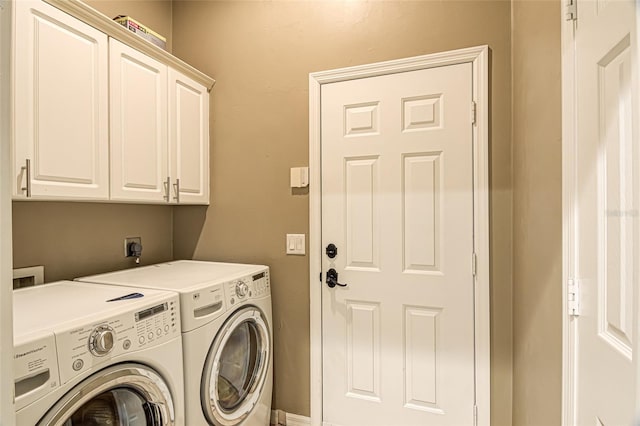 laundry room with cabinets and washing machine and dryer