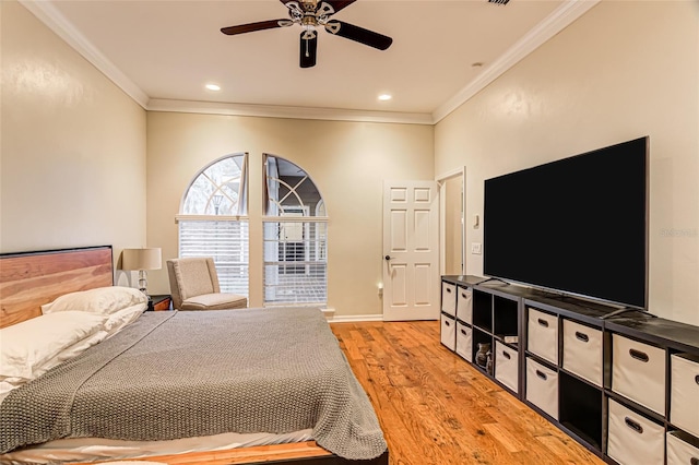 bedroom featuring crown molding, ceiling fan, and light hardwood / wood-style floors