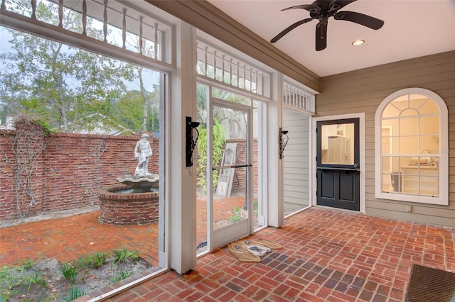 sunroom featuring a wealth of natural light and ceiling fan