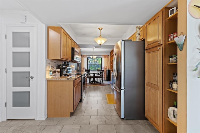 kitchen featuring backsplash, stainless steel appliances, light stone counters, a notable chandelier, and decorative light fixtures