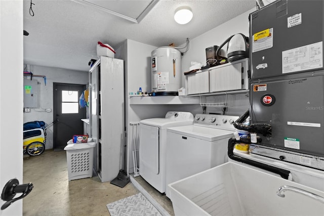 clothes washing area featuring sink, water heater, cabinets, a textured ceiling, and washing machine and clothes dryer