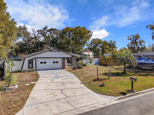 single story home with a garage and a front lawn