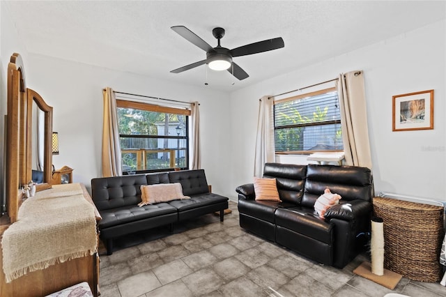 living room featuring ceiling fan, a textured ceiling, and a wealth of natural light