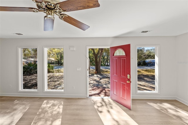 foyer entrance with ceiling fan and light hardwood / wood-style flooring