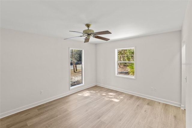 spare room featuring light wood-type flooring and ceiling fan