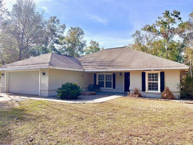 ranch-style home featuring a garage and a front lawn