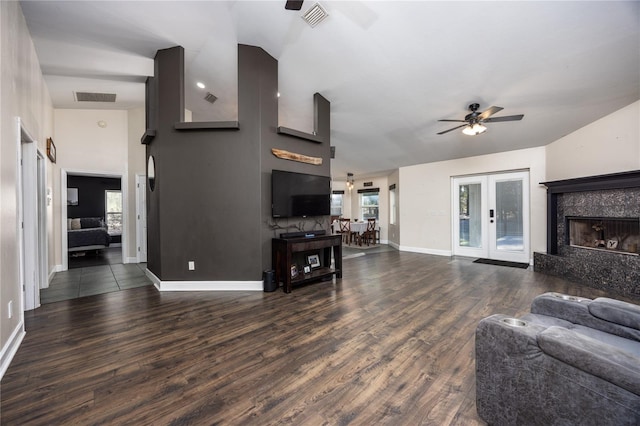 living room featuring a fireplace, dark hardwood / wood-style floors, ceiling fan, and french doors