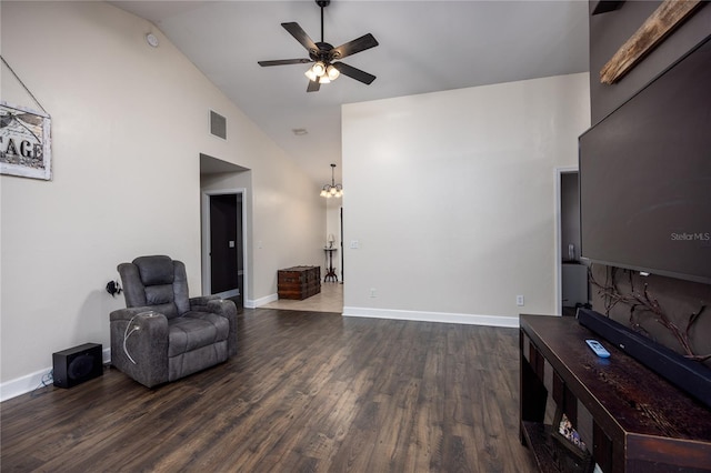 living area with lofted ceiling, dark hardwood / wood-style floors, and ceiling fan