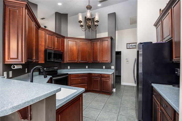 kitchen with an inviting chandelier, black electric range, light tile patterned floors, stainless steel fridge, and pendant lighting