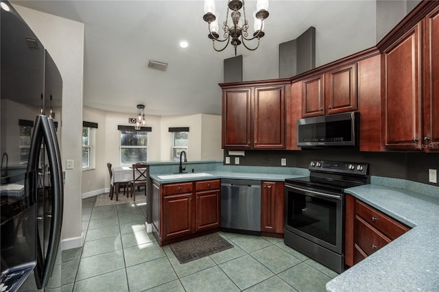 kitchen featuring appliances with stainless steel finishes, sink, a chandelier, hanging light fixtures, and light tile patterned floors