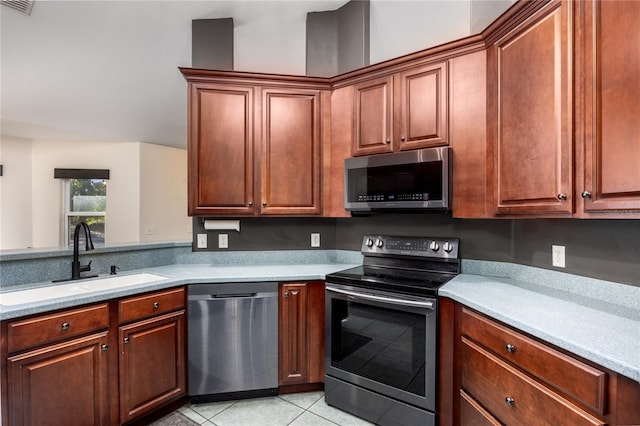 kitchen featuring appliances with stainless steel finishes, sink, and light tile patterned floors