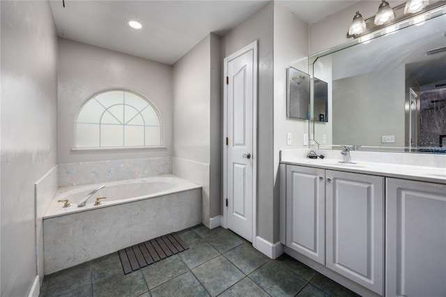 bathroom with vanity, tile patterned flooring, and a bathing tub