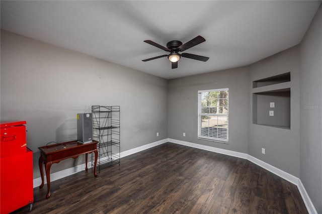 empty room featuring ceiling fan and dark hardwood / wood-style flooring