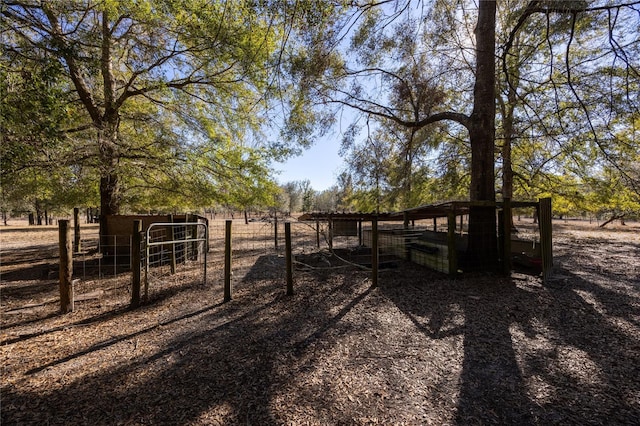 view of yard with a rural view and an outbuilding