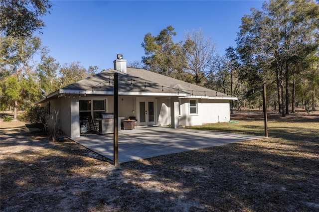 rear view of house with french doors and a patio