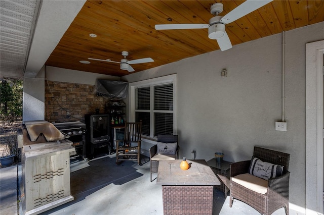 view of patio featuring ceiling fan and exterior kitchen