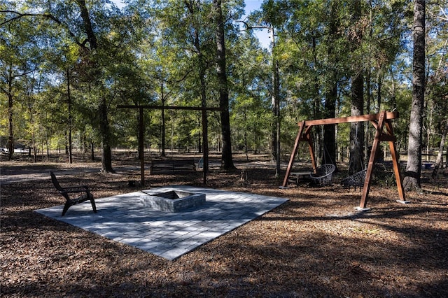 view of play area featuring a patio and a fire pit