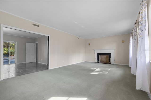 unfurnished living room featuring dark carpet and ornamental molding