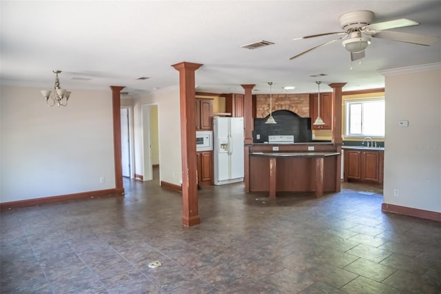 kitchen with ornate columns, sink, pendant lighting, and white appliances